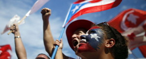 Supporters of Alejandro Garcia Padilla, candidate for governor of the pro-commonwealth Popular Democratic Party, cheer during his closing campaign rally in San Juan, Puerto Rico, Sunday, Nov. 4, 2012. Puerto Rican voters will once again ponder the decades-old question over the island's political future when they go to the polls Tuesday: What kind of relationship do they really want with the United States? Officially, the Caribbean island is the U.S. Commonwealth of Puerto Rico, a semi-autonomous extension of the U.S. mainland, its giant neighbor 1,000 miles to the northwest. (AP Photo/Ricardo Arduengo)