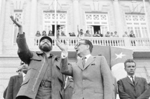 Chiles President Salvador Allende, right, talks to Cubas Fidel Castro, as they acknowledge cheers during the outdoor rally they attended at this Pacific Ocean port in Valparaiso, Chile  Nov. 30, 1971. (AP Photo)