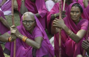 Members of a 'gulabi gang' (pink gang), a women's vigilante group, as they meet for a protest in Allahabad, India, Monday, July 6, 2009. The group is so named after their pink dresses that they wear and was formed in Uttar Pradesh State's Banda district. They brandish sticks and fight for social issues and one of their demands is to ban the sale of liquor in the villages. (AP Photo / Rajesh Kumar Singh)